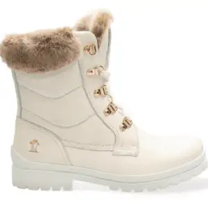 Bota de la marca Panama Jack de mujer plana con cordones, realizada en piel Waterproof de color hielo que repele el agua. Esta bota tiene forro interior de pelo, perfecto para mantener los pies calientes en días de frío. Plantilla anatómica extraíble y suela de caucho natural flexible y resistente. Altura caña: 20 cm.